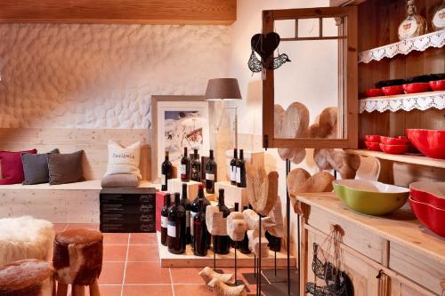 a room with a bunch of wine bottles on a counter at der grüne Baum Mountain Boutique Hotel in Ehrwald