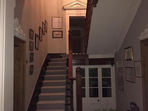 a staircase in a house with a stair case at Ballyteige Lodge in Ballyteige Bridge