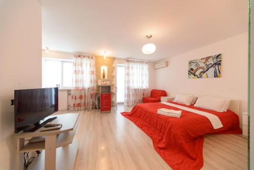 a bedroom with a large bed with a red blanket at Partner Guest House Saksahans'koho in Kyiv