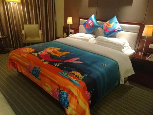 a bed in a hotel room with a dragon blanket at Kunming Haitian Hotel in Kunming