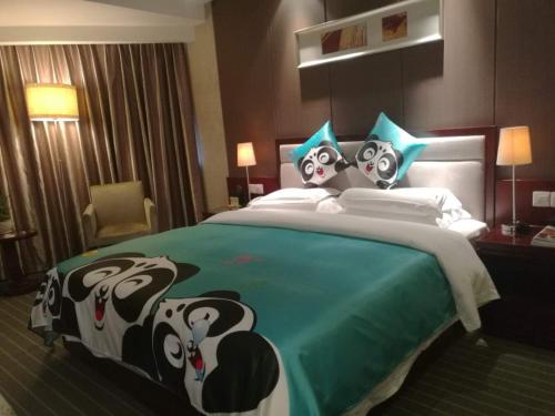 a large bed in a hotel room with pandas on it at Kunming Haitian Hotel in Kunming