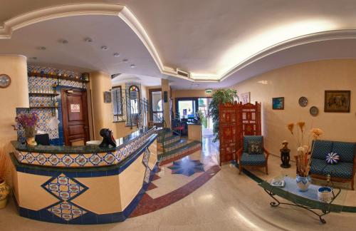 a lobby with a staircase in a building at Al-Tair in San Vito lo Capo