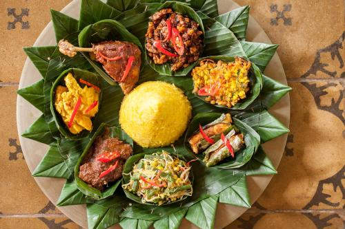 a plate of food with different types of food at Balquisse Heritage Hotel in Jimbaran