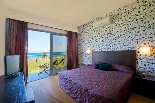 Un pat sau paturi într-o cameră la Natura Beach Hotel And Villas