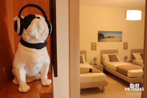 a dog wearing headphones sitting in a room at B&B Pietrarsa in Portici