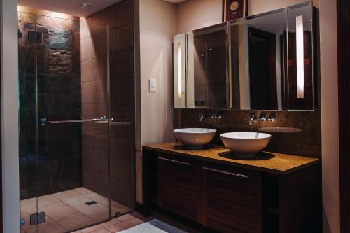 a bathroom with two sinks and a shower at Aquamarine in Eden Island