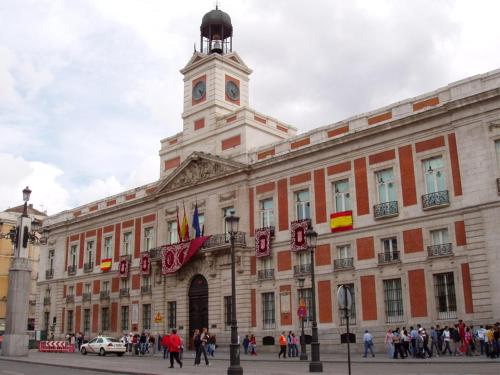 a large building with a clock tower on top of it at Alhambra Suites in Madrid