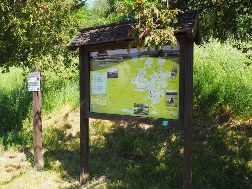 a sign in the middle of a field at La Balade du Ricochet in Tenneville