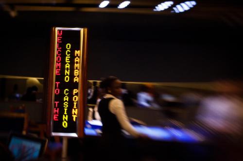 a sign that is in front of a casino at Mamba Point Hotel in Monrovia