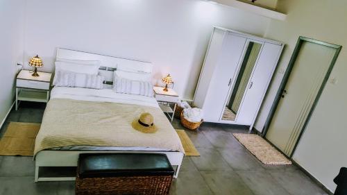 a bedroom with a large bed and two mirrors at Mol Hahr in Safed