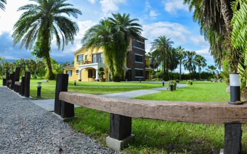 a park with a bench in front of a building at Greenfield Villa in Fengping