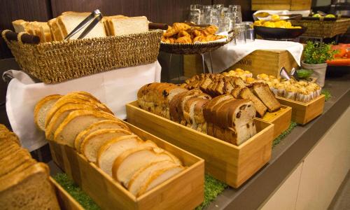 a buffet of bread and pastries on a table at Novotel Sydney Parramatta in Sydney