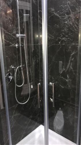 a shower with a glass door in a bathroom at Donna Margharet in Crotone