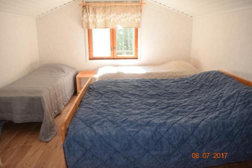 Ένα ή περισσότερα κρεβάτια σε δωμάτιο στο Lomakoti Tuulensuoja