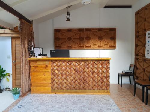 a wooden gate in a room with a wall at Holiday Garden Rasdhoo in Rasdu