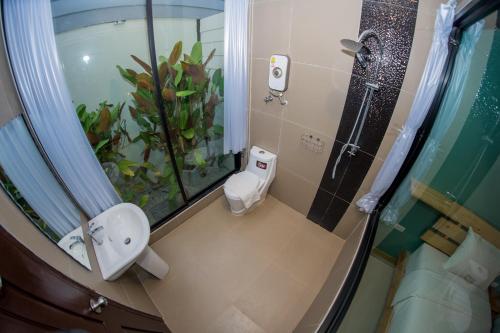 a bathroom with a sink and a plant in the shower at Rest Time Hotel in Nong Khai