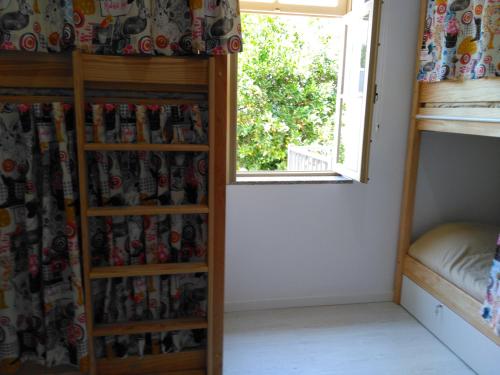 a room with a bunk bed and a window at Águeda Hostel & Friends in Águeda