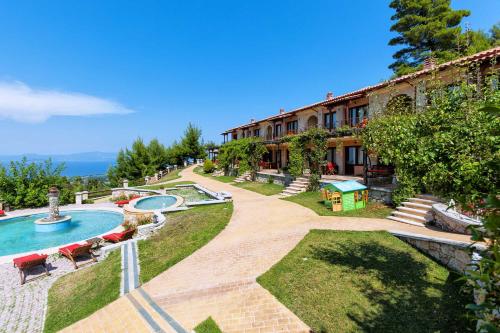 a resort with a swimming pool and a building at Akritas Ef Zin Villas & Suites in Paliouri