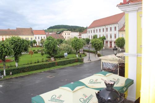 a view of a town from a balcony with umbrellas at Ferdinand Apartments in Mediaş