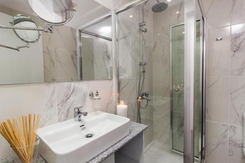a bathroom with a sink and a shower at Art & Wine Boutique Hotel in Larnaka