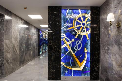 a hallway with astained glass wall in a building at Medi Terre Boutique Hotel - By Saida Hotels in Netanya
