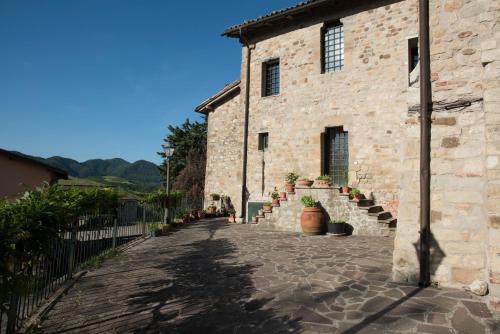 a stone building with a stairway in front of it at Tenuta Folesano Wine Estate 13th century in Marzabotto