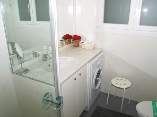 a white bathroom with a sink and a washing machine at Newly Renovated Apt in Kolonaki in Athens