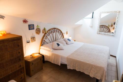 a bedroom with a bed and a dresser at Cristallo Verde Mare in Alba Adriatica
