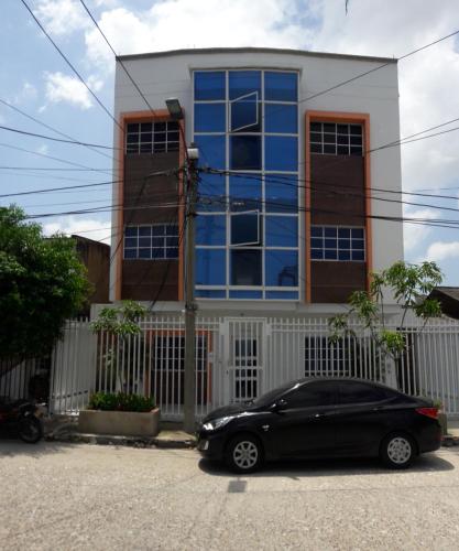 a black car parked in front of a house at Hotel Torres del Parque No3 in Barranquilla