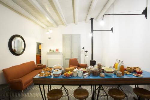 a living room with a table with food on it at Intervallo Boutique Hotel in Ragusa
