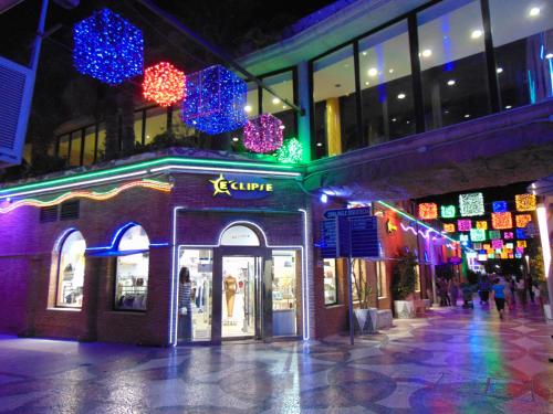 a store with christmas lights on a street at night at Apartamentos varios con 2 dorm en Marina Dor , la playa de Amplaries 47 , vista lateral al mar in Oropesa del Mar