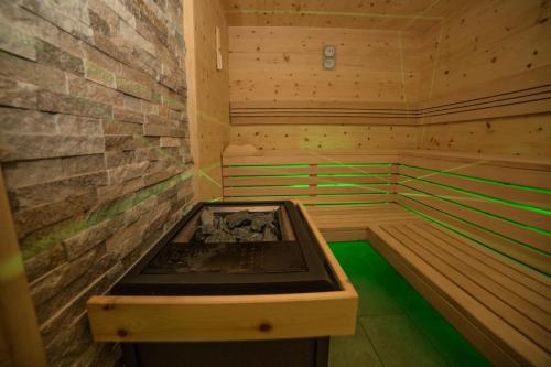a wooden sauna with a hot tub in it at Hotel Garni Savoy - new opening in Castelrotto