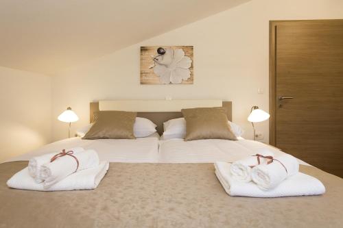 a bedroom with two beds with towels on them at Villa Rusula in Kastel Novi