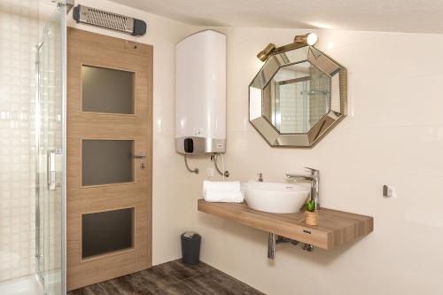 a bathroom with a sink and a mirror at Villa Rusula in Kastel Novi