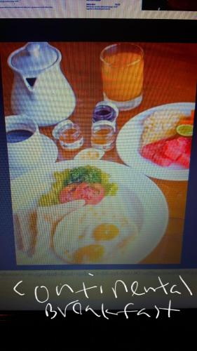 a table with plates of food and glasses of wine at Holiday Inn Unawatuna in Unawatuna