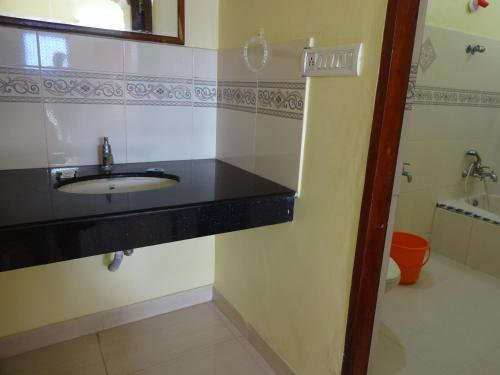 a bathroom with a sink and a toilet at Hotel Sea View Palace - the beach hotel in Kovalam