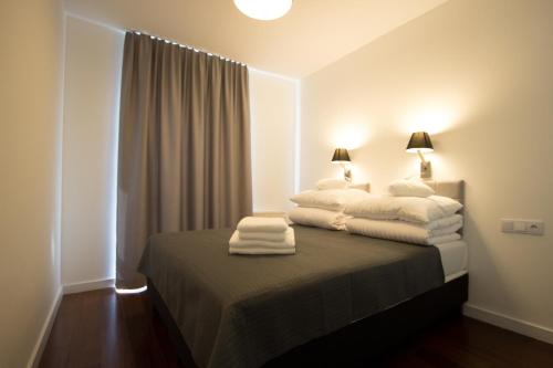 Кровать или кровати в номере Lenzo Apartments