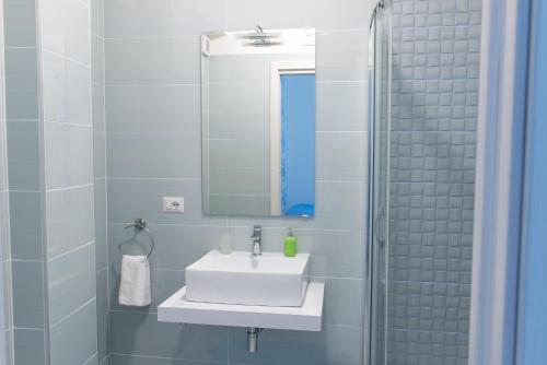 a bathroom with a white sink and a mirror at Villa Milena in Agropoli