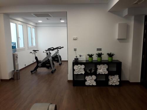 a gym with two treadmills and two exercise bikes at Mercure Monte Igueldo in Donostia-San Sebastián