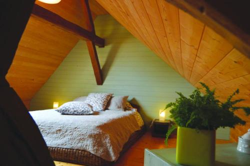 a bedroom with a bed in a attic at Epi-Centre in Préaux