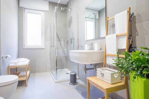 a bathroom with a sink and a shower and a toilet at Oikos in Matera