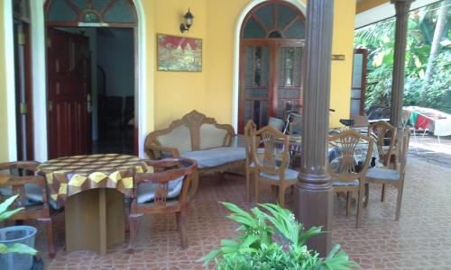 a room with chairs and a table and a table and chairs at Grace Villa Bentota in Bentota