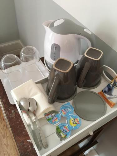 a kitchen counter with a coffee maker and utensils at Chambres d'Hôtes Au coin du spa in Boulogne-sur-Mer