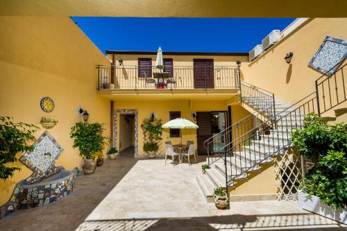 an external view of a house with stairs and a patio at Appartamenti il Patio in San Vito lo Capo