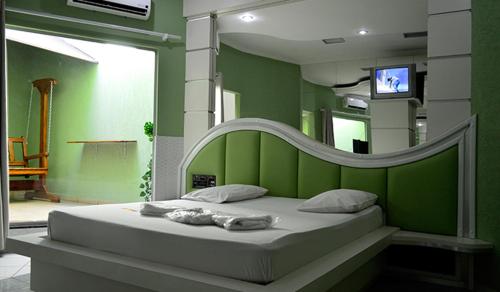 מיטה או מיטות בחדר ב-Flamboyant Hotel