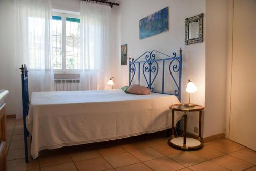 a bedroom with a bed with a blue metal frame at Villa in Punta Ala in Punta Ala