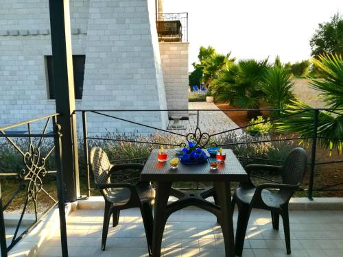 a table on a balcony with two chairs at Albadido in Campomarino