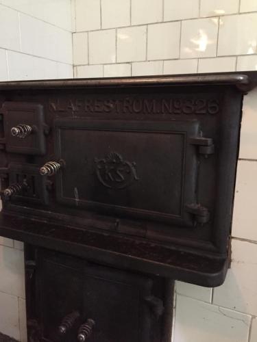 an old woodburning stove in a wall at Domsjö Apartment in Örnsköldsvik