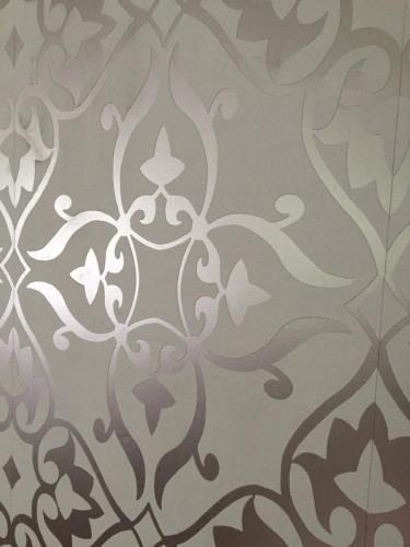a wall stencil of a floral pattern on a wall at Domsjö Apartment in Örnsköldsvik
