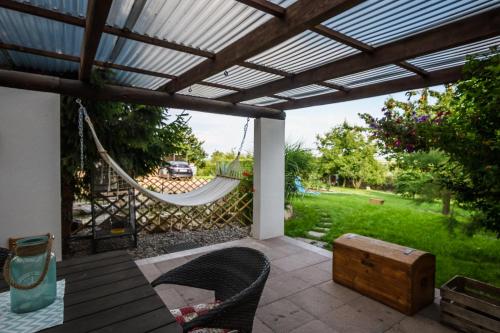 a patio with a hammock and a view of a yard at Penzion Labská Vyhlídka in Litoměřice